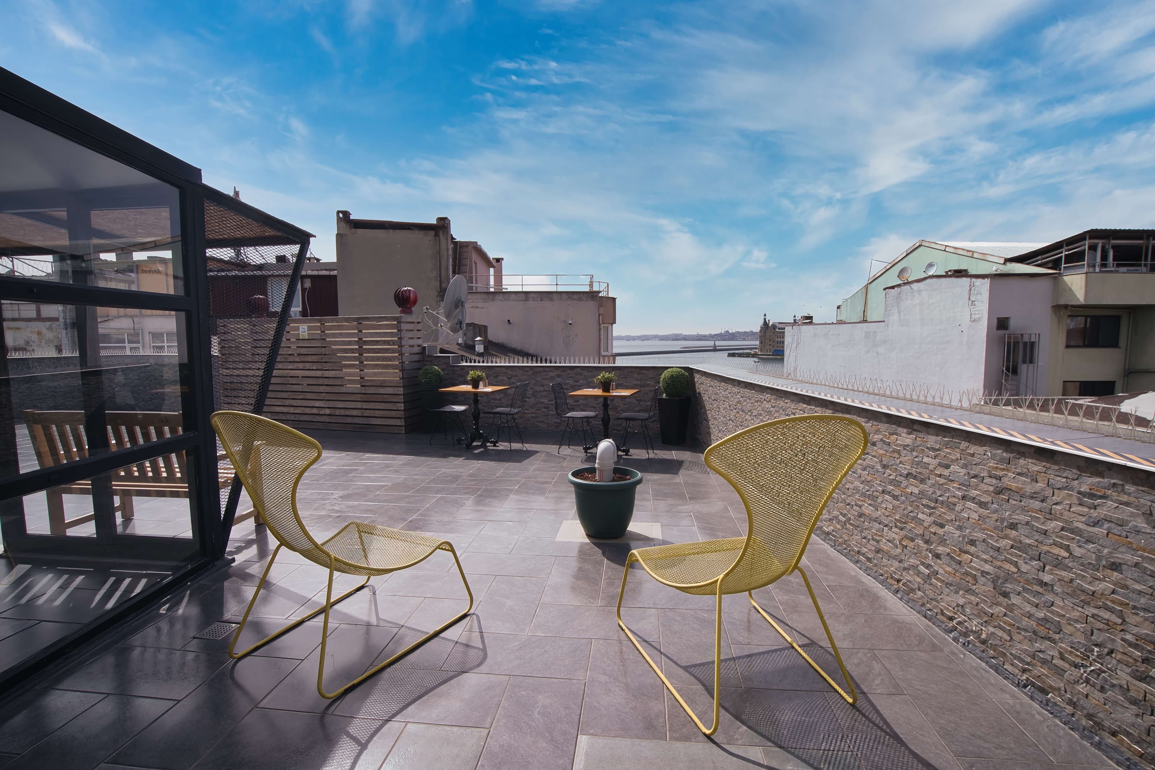 Yellow lounge chairs facing the Bosphorus and Haydarpaşa