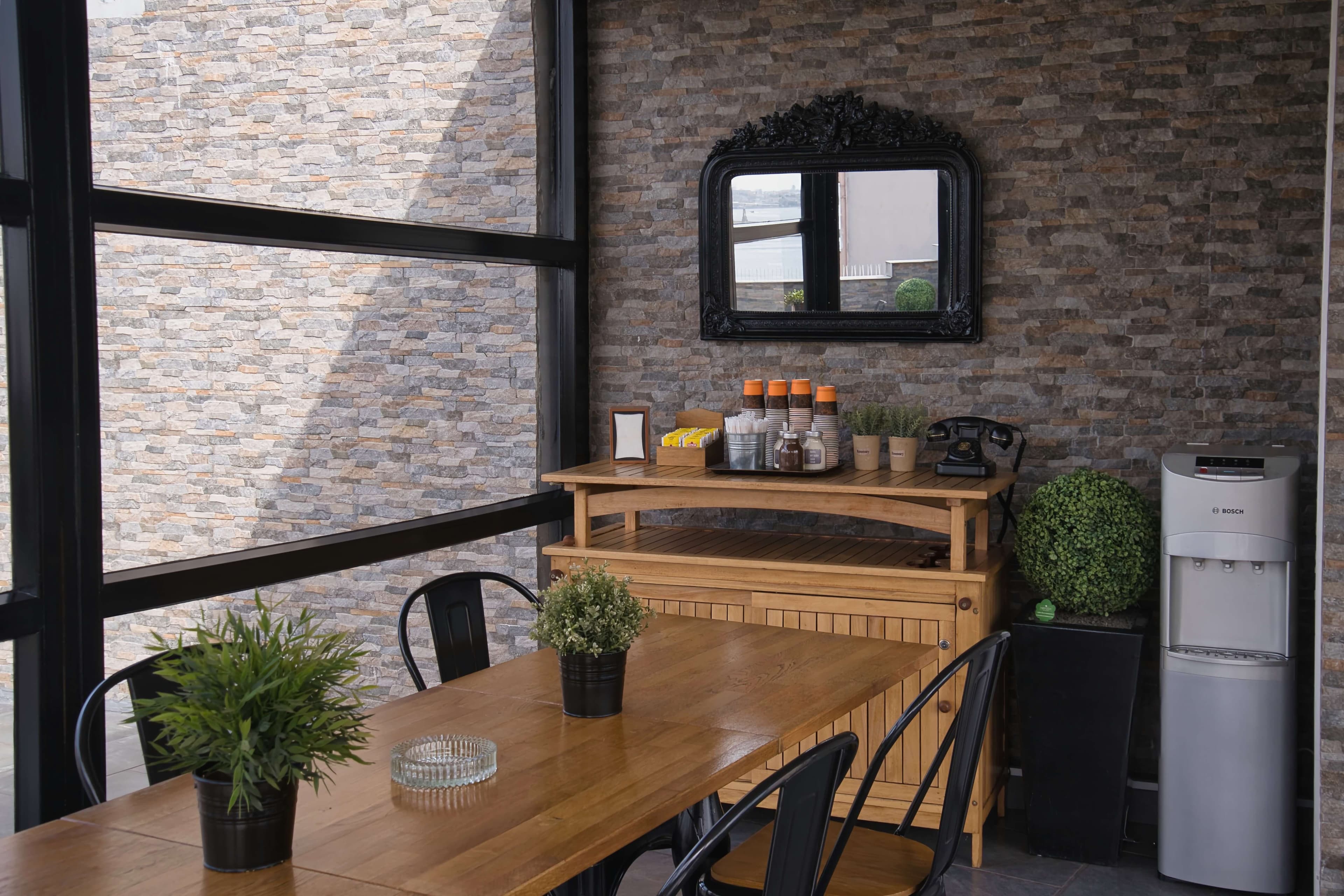 Glass lounge with self-serve tea and coffee station